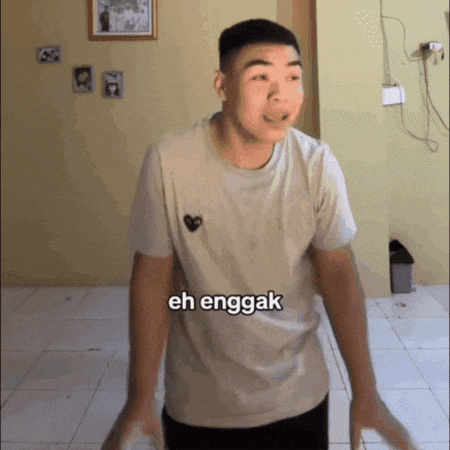 a man wearing a white shirt with a heart on it says eh enggak