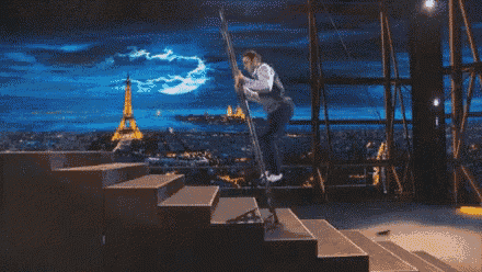 a man is climbing up stairs with the eiffel tower in the background .