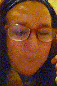 a close up of a woman wearing glasses and a bandana