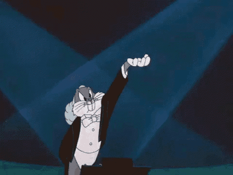 bugs bunny is wearing a tuxedo and bow tie and giving the thumbs up