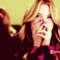 a close up of a woman covering her mouth with her hands with a abc family logo in the background
