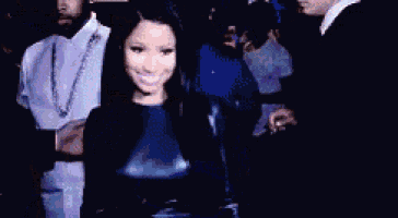 a group of people are standing next to each other and smiling .
