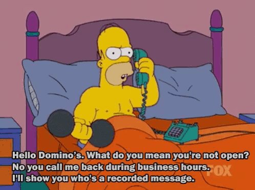 homer simpson is talking on a phone while holding a dumbbell