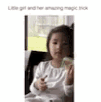 a little girl is sitting in a chair eating a green apple .