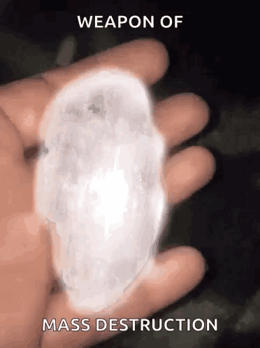 a person is holding a piece of ice in their hand with the words " weapon of mass destruction " above it
