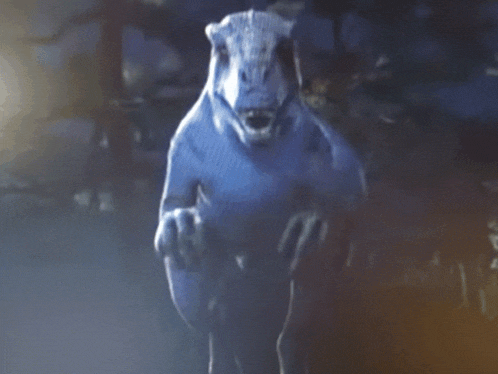 a close up of a dinosaur 's face with a blurry background