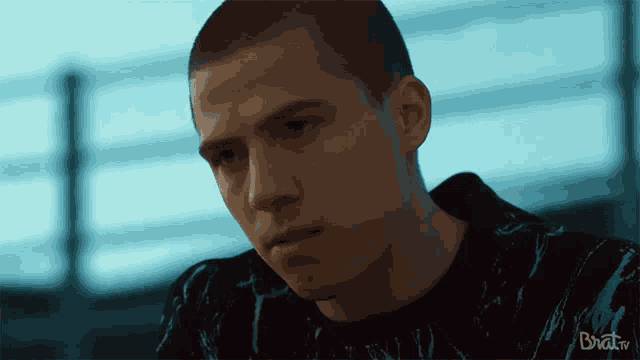 a close up of a man 's face with the words brat.tv in the bottom right corner
