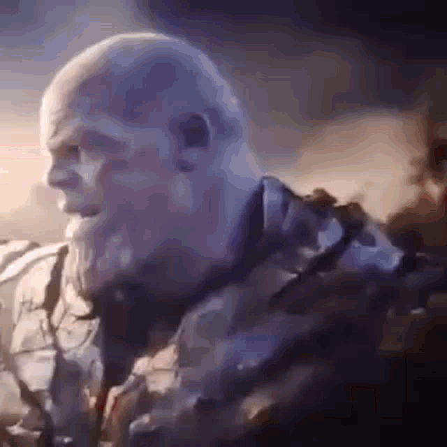 a close up of thanos from avengers : infinity war looking at something .