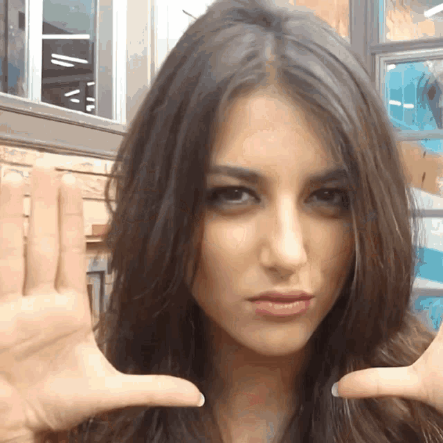 a woman is making a stop gesture with her hands