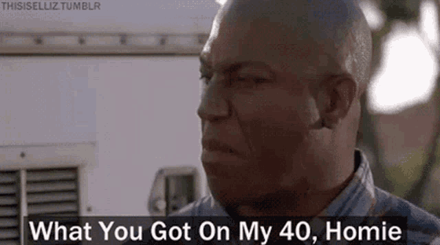 a bald man is standing in front of a white van and talking to someone .