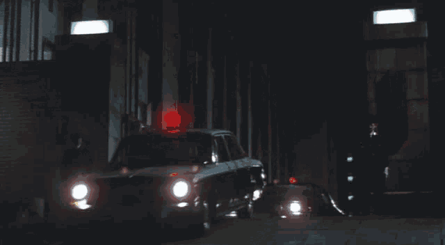 a few cars are parked in a dark garage