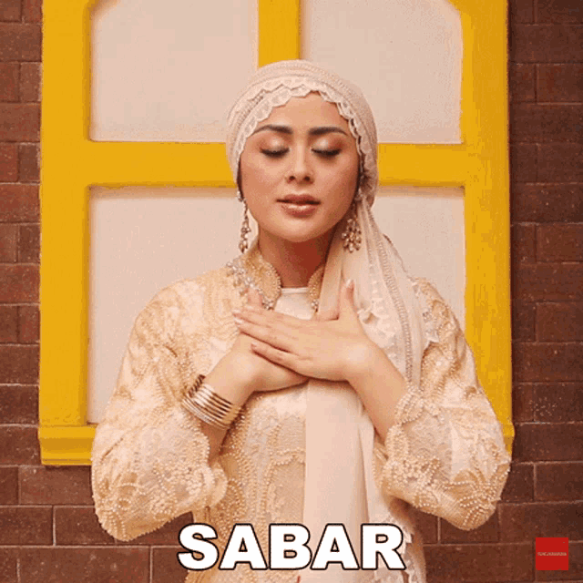 a woman with her hands on her chest with the word sabar written above her