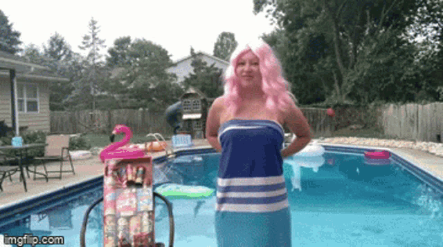 a woman in a pink wig stands in front of a pool