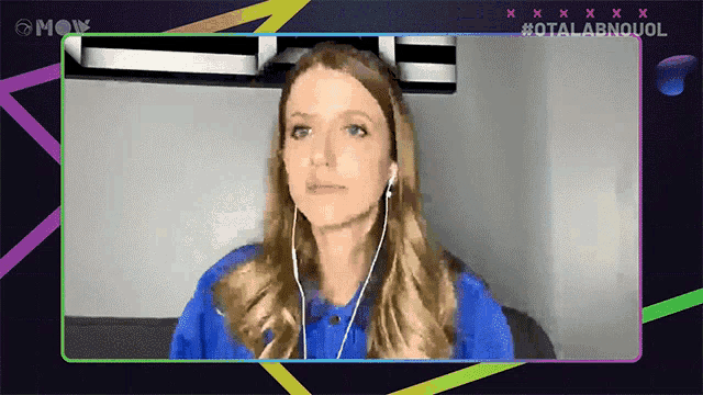 a woman wearing ear buds and a blue shirt is on a screen that says #otalabnquol