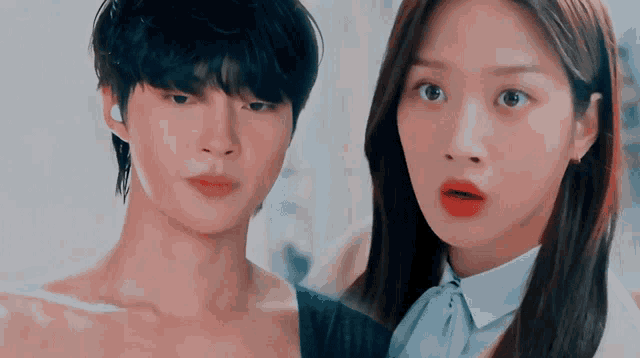 a man and a woman are standing next to each other and looking at each other
