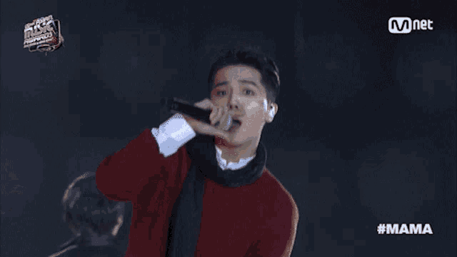 a man singing into a microphone with the hashtag mama