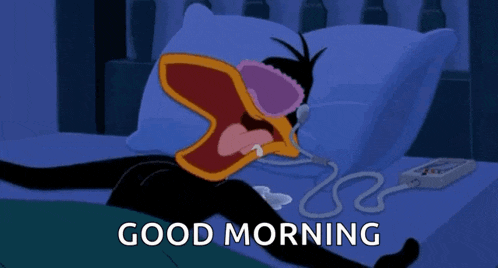a cartoon of a duck laying on a bed with the words good morning above him