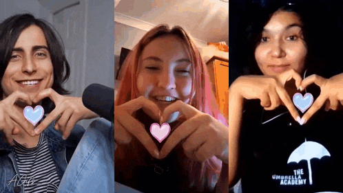 a man and two women are making a heart shape with their hands ..