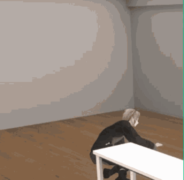 a person sitting at a table in a room