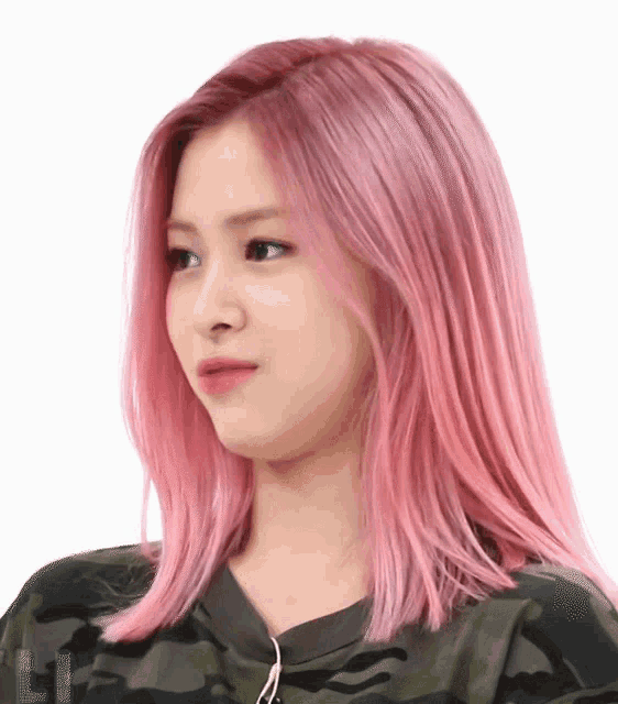 a woman with pink hair is wearing a camo shirt .