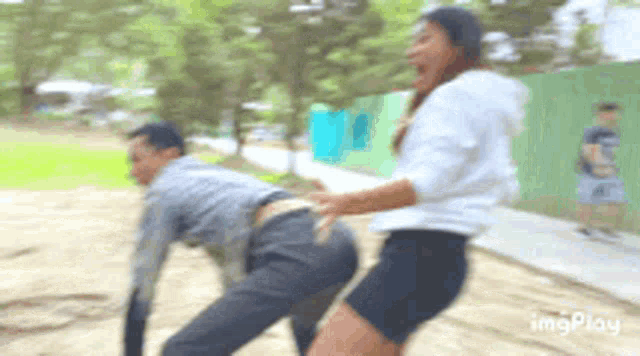 a blurry picture of a man and a woman with the words imgplay on the bottom right