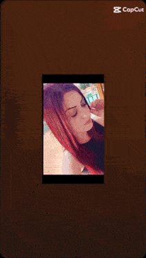 a picture of a woman with red hair is shown on a phone screen