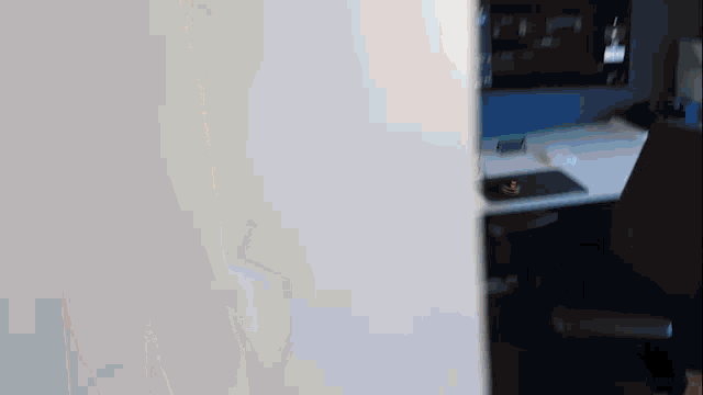 a blurred image of a desk and chair with a computer on it