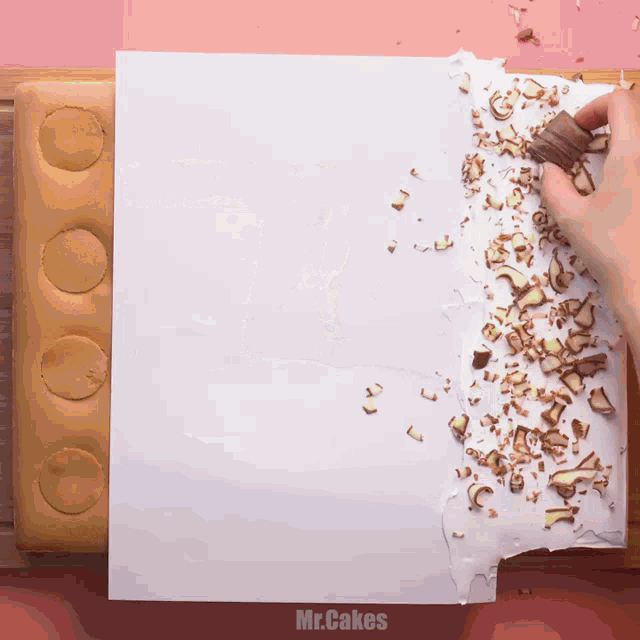 a person is holding a chocolate bar on a piece of paper that says mr.cakes