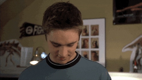 a young man in a room with a sign that says fight on it