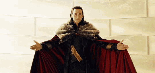 a man in a fur cape is standing in front of a wall