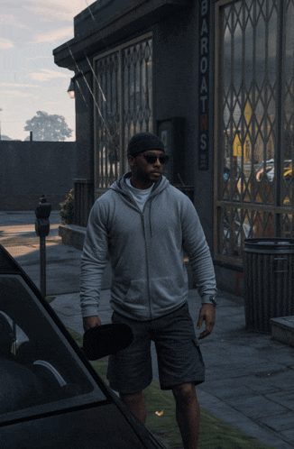 a man in a hoodie stands in front of a building that says bar oats