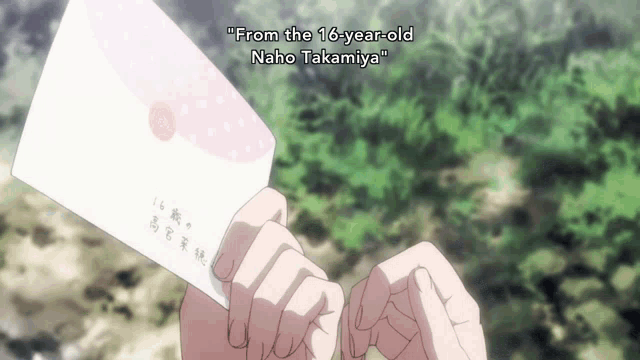 a person holding an envelope that says " from the 16 year old naho takamiya " on it