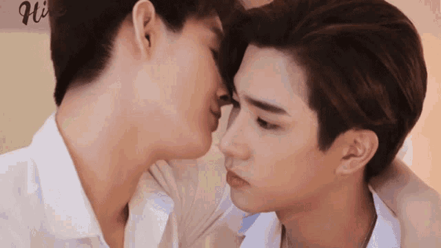 two men kissing with the word hi on the bottom