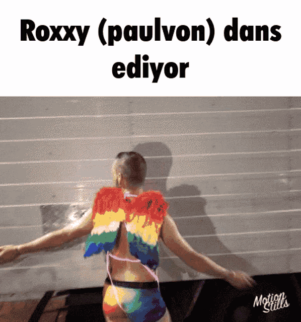 a man in a rainbow outfit is dancing with the words roxxy ( paulvon ) dans ediyor written above him
