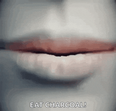a close up of a person 's mouth with the words eat charcoal written on it