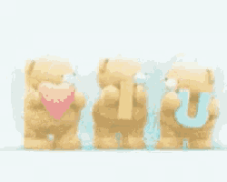 three teddy bears standing next to each other holding a heart and the word i love you