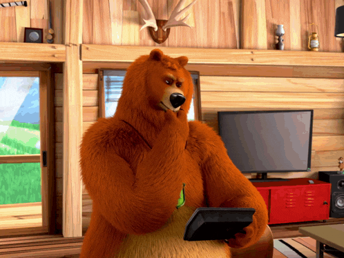 a bear is holding a tablet in front of a television