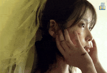 a close up of a woman 's face with the word iu on the bottom right