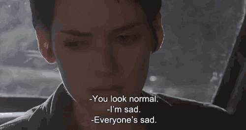 a close up of a person 's face with a caption that says " you look normal i 'm sad everyone 's sad
