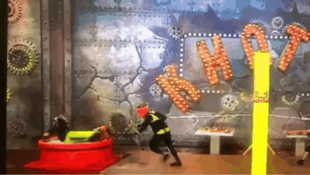 a person is standing in front of a wall with the word hot on it
