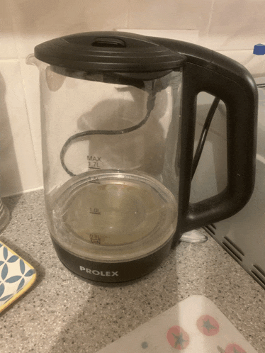 a black prolex electric kettle sits on a counter