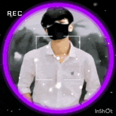a man wearing a black mask and a white shirt is standing in a purple circle .