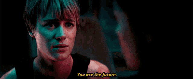 a man and a woman are sitting in a car and the woman is saying `` you are the future ''