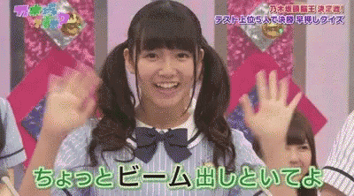 a girl with pigtails and a bow tie is smiling and raising her hands