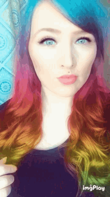 a woman with rainbow hair is taking a selfie with imgplay in the lower right corner