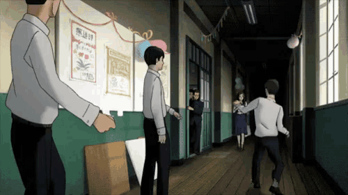 a group of people standing in a hallway with a sign on the wall that says ' a '