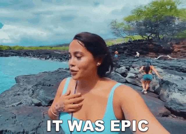a woman taking a selfie on a rocky beach with the words " it was epic " on the bottom