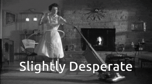 a black and white photo of a woman using a vacuum cleaner with the words slightly desperate written below her