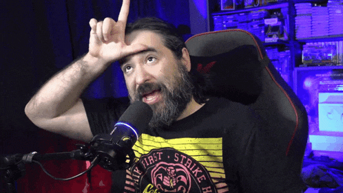 a man wearing a shirt that says fight strike is sitting in front of a microphone