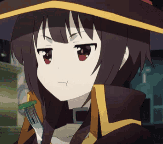 a girl in a witch hat is holding a fork and making a face